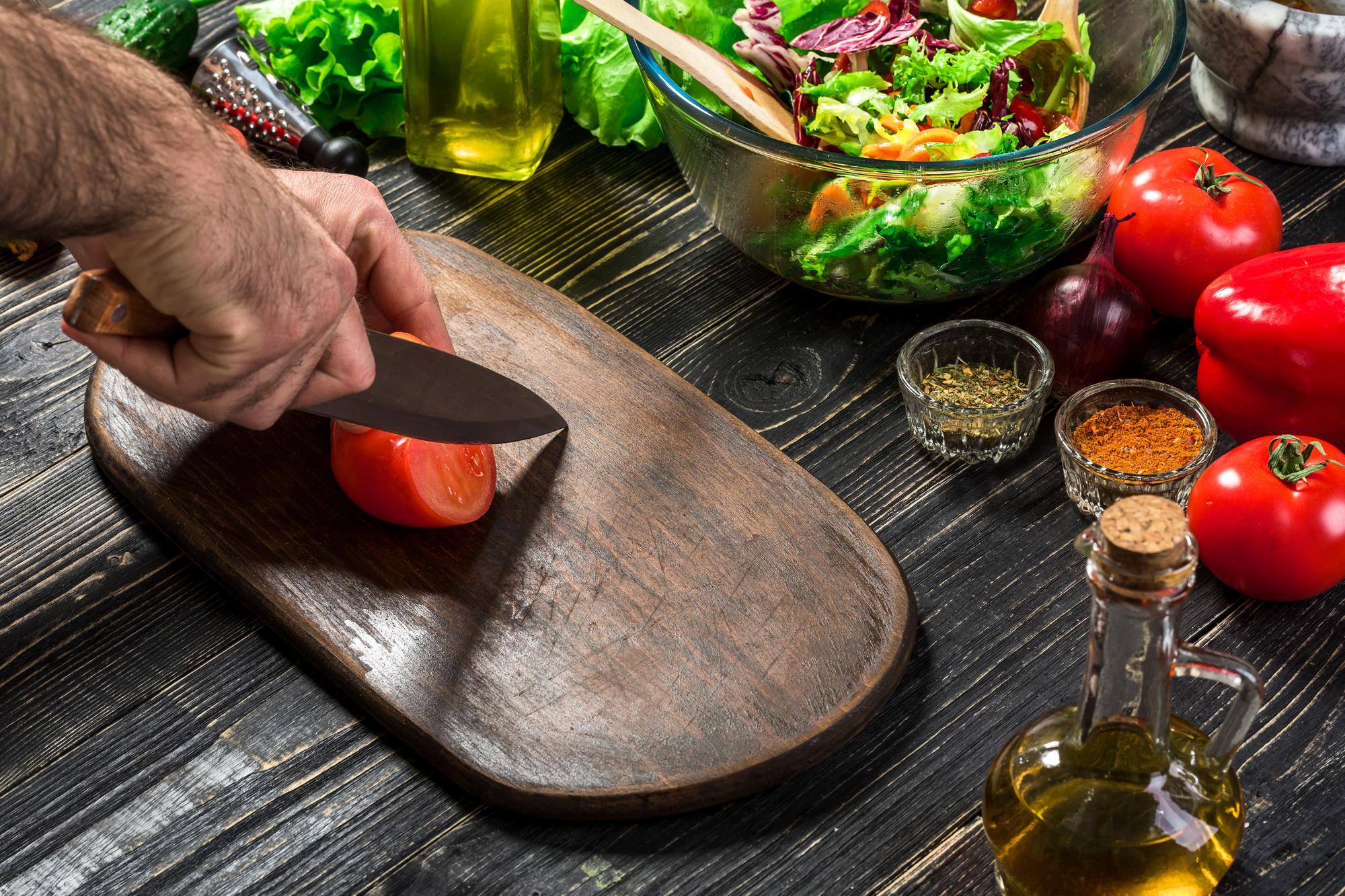 Chef slicing roasted vegetables